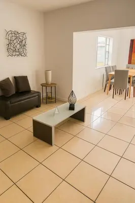 a living room with a couch and a table at Fauna Bizcaya in Gold Coast Heliport