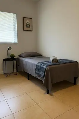 a bedroom with a bed with a blanket on it at Fauna Bizcaya in Gold Coast Heliport