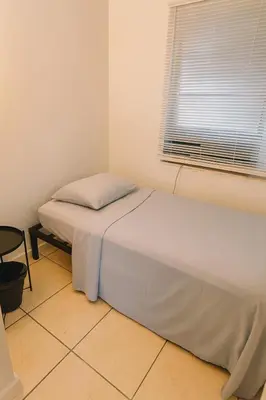 a small bedroom with a bed and a window at Fauna Bizcaya in Gold Coast Heliport