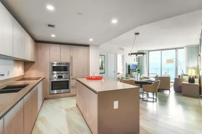 a kitchen and living room with a dining room at Luxury Beachfront Condo W Top Amenities in Hollywood