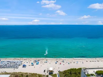an aerial view of a beach with a group of people at Luxury Beachfront Condo W Top Amenities in Hollywood