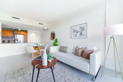 a white living room with a white couch and a table at Beautiful and Stylish Condo Close The Doral Park in Miami