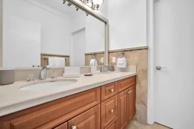 a bathroom with a sink and a large mirror at Grove Walk Manor 3BR Oasis in the Grove Family in Miami