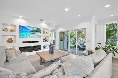 a living room with a couch and a table at Grove Walk Manor 3BR Oasis in the Grove Family in Miami