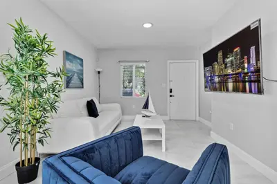 a living room with a white couch and blue chairs at Celeste House Enjoy Caribbean 2BR APT in Miami