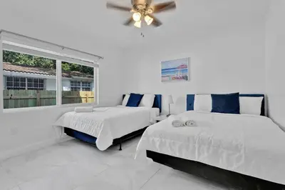 a bedroom with two beds and a window at Celeste House Enjoy Caribbean 2BR APT in Miami