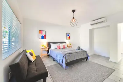 a bedroom with a bed and a couch at Beach and Art Close to This Lovely Studio in Miami