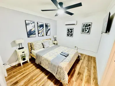 a bedroom with a bed and a ceiling fan at Retreat in Style Private Peaceful Miami Bungalow in Olympia Heights