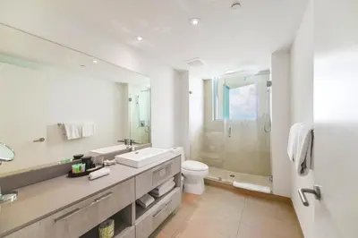 a bathroom with a sink and a toilet and a shower at Stunning Oceanfront Escape & Luxury Resort Living in Hollywood