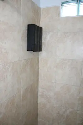 a shower with a black speaker in a bathroom at Coral Gables Guest Studio in Miami