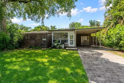 a home with a patio and a yard at The Jungalo Pool & Billards in Fort Lauderdale