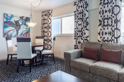 a living room with a couch and a table at Solara Surfside in Miami Beach