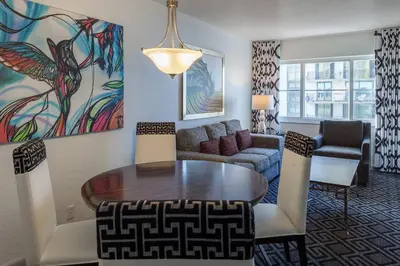 a living room with a table and a couch at Solara Surfside in Miami Beach
