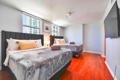 a bedroom with two beds and a tv in it at Upscale Condo in Brickell in Miami