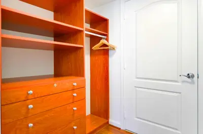 a closet with a wooden dresser and a white door at Upscale Condo in Brickell in Miami