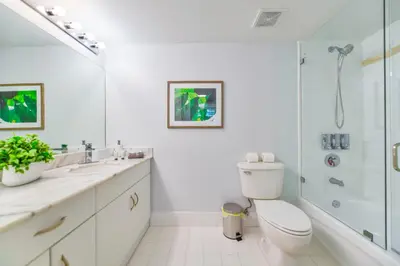 a white bathroom with a toilet and a shower at Upscale Condo in Brickell in Miami