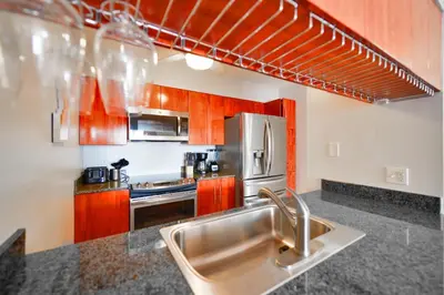 a kitchen with a sink and a stainless steel refrigerator at Upscale Condo in Brickell in Miami