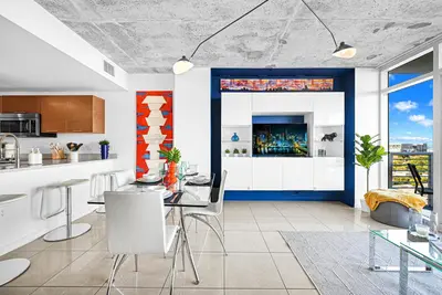 a kitchen and living room with a table and chairs at Exclusive unit in Miami Sunshine in Miami