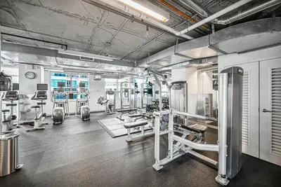 a gym with several treadmills and machines at Exclusive unit in Miami Sunshine in Miami