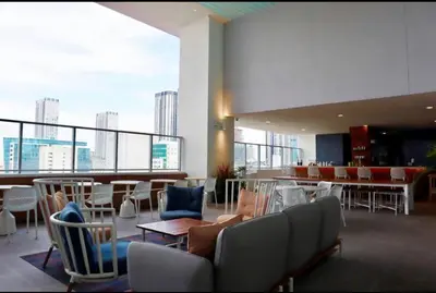 a lobby with chairs and tables and a view of the city at Modern Luxe Studio in Downtown Miami with Rooftop Pool and Gym in Miami