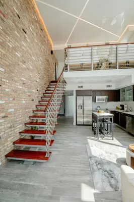 a brick wall with a staircase in a kitchen at LOFT Brickell River 10 min To South Beach in Miami