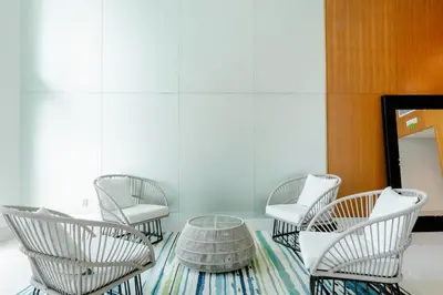 four white chairs and a table in a room at LOFT Brickell River 10 min To South Beach in Miami