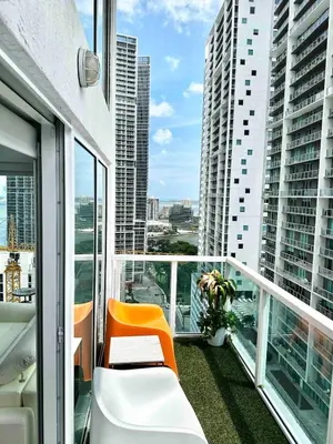 an apartment balcony with a view of a city at LOFT Brickell River 10 min To South Beach in Miami