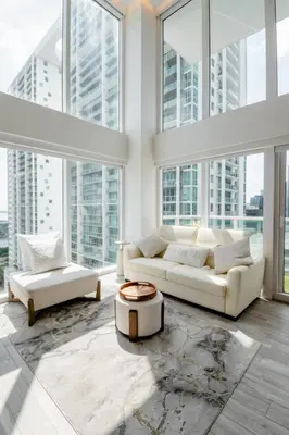 a living room with white furniture and large windows at LOFT Brickell River 10 min To South Beach in Miami