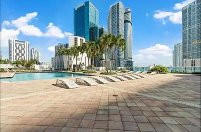 a pool in the middle of a city with tall buildings at LOFT Brickell River 10 min To South Beach in Miami