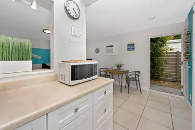 a kitchen with a microwave on a counter with a table at Ocean Breeze Home in Hollywood