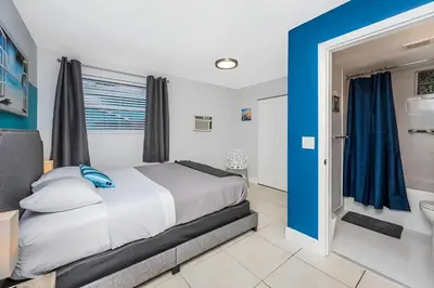 a bedroom with a bed and a bathroom at Ocean Breeze Home in Hollywood
