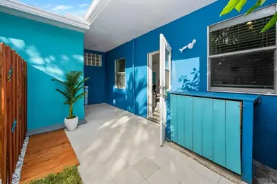 a blue room with a blue wall and a window at Ocean Breeze Home in Hollywood