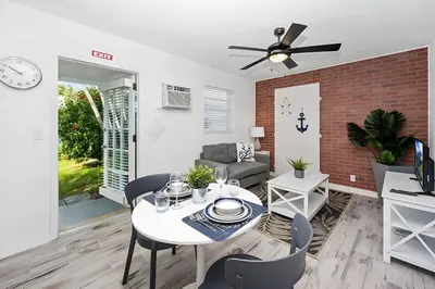 a living room with a white table and chairs at Luna Beach House in Hollywood
