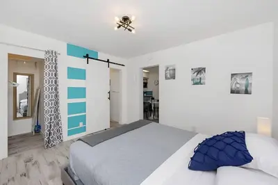 a bedroom with a bed and a ceiling fan at Luna Beach House in Hollywood