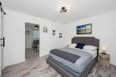 a bedroom with a bed and a ceiling fan at Luna Beach House in Hollywood