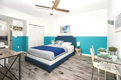 a bedroom with a bed and a dining table at Blue Coral Studio in Hollywood