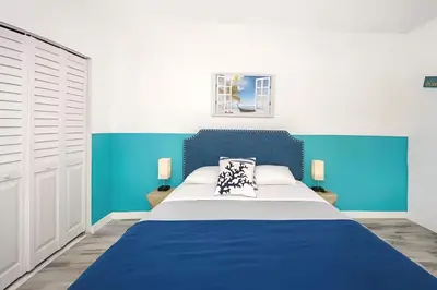 a blue and white bedroom with a large bed at Blue Coral Studio in Hollywood