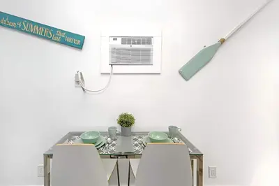 a kitchen with a table with chairs and an air conditioner at Blue Coral Studio in Hollywood