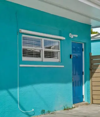 a blue house with a window and a blue door at Blue Coral Studio in Hollywood