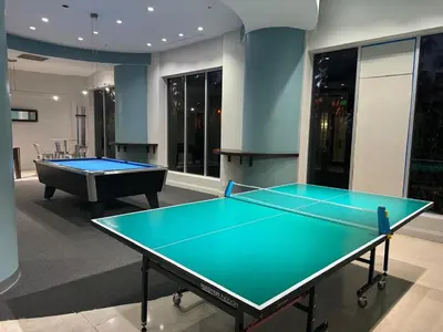 two ping pong tables in a room with a pool table at Ocean view-Large 2bedroom Remodeled on the beach in Hollywood