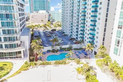 an aerial view of a resort with a pool and palm trees at Ocean view-Large 2bedroom Remodeled on the beach in Hollywood