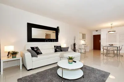 a living room with a white couch and a table at Ocean front, full equiped, pool and parking 2M in Hollywood