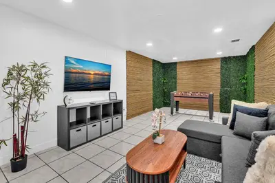 a living room with a couch and a table at Hollywood Beach & Casino Heated Pool House in Hollywood