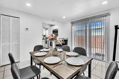 a dining room with a wooden table and chairs at Hollywood Beach & Casino Heated Pool House in Hollywood