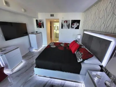 a bedroom with a couch and a flat screen tv at 2b 2b Beautiful Apmt in Hallandale Beach with beach service in Hallandale Beach
