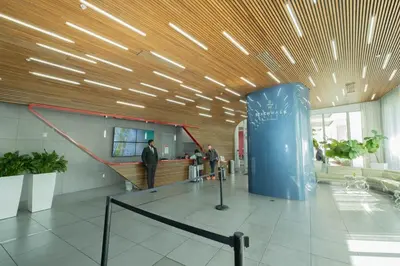 a lobby of an airport with people standing in a building at 2B 2B Beachfront Pool Gym, and Restaurant in Hallandale Beach