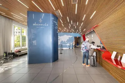 a man standing in a lobby with a hat on his head at Steps from the beach 2B 2B Pool, Gym, and More in Hallandale Beach