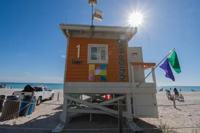 a lifeguard tower on the beach with a truck at Beachfront Apt with Pool by the Ocean in Hallandale Beach