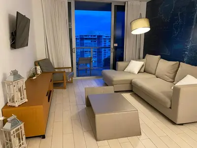 a living room with a couch and a table at Beachfront Apt with Pool by the Ocean in Hallandale Beach