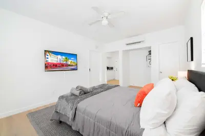 a bedroom with a bed and a tv on a wall at Stylish Studio Near Miami Relevant Spots in Miami